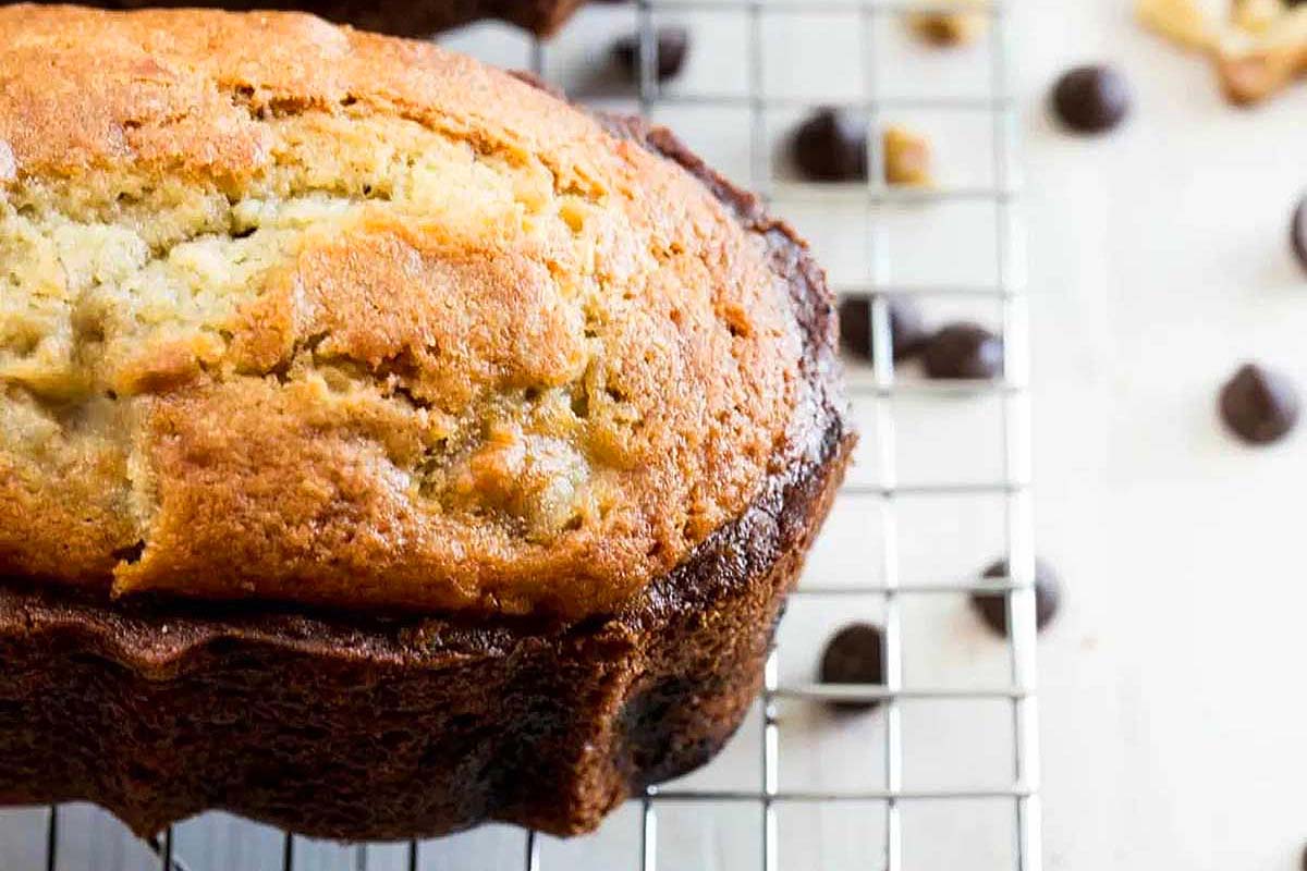 Two slices of banana bread on a cooling rack.