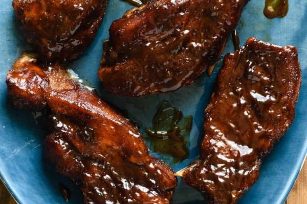 Pork ribs with sticky glaze on a plate.