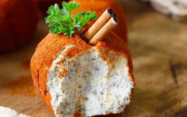 Cream cheese balls with parsley greens on top.