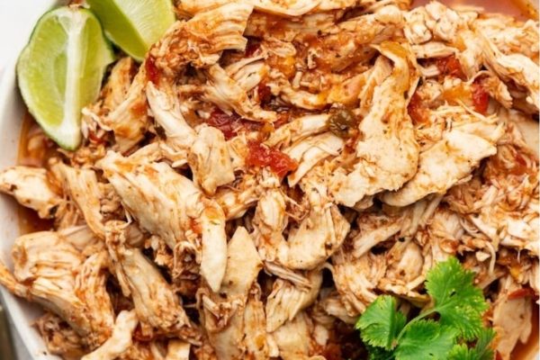 Crockpot chicken and salsa in a serving dish.