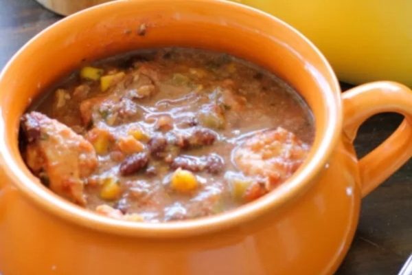 Crockpot southwest chicken soup in an orange bowl.