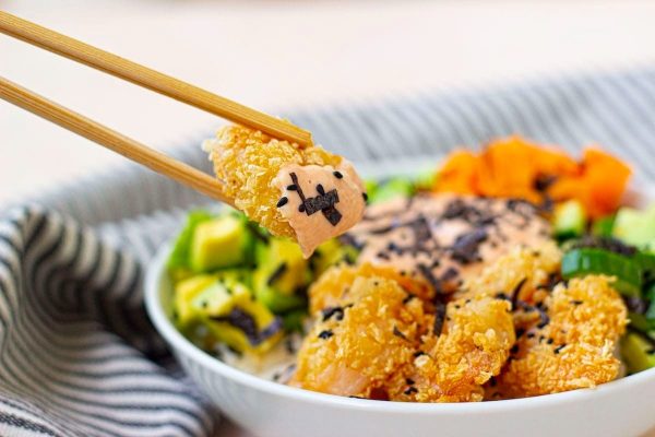 Pieces of crunchy shrimp sushi bowl with chopsticks.