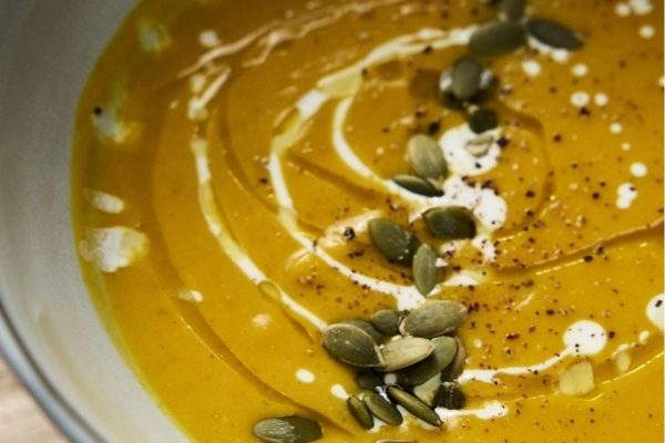 Curried squash and apple soup in a bowl.