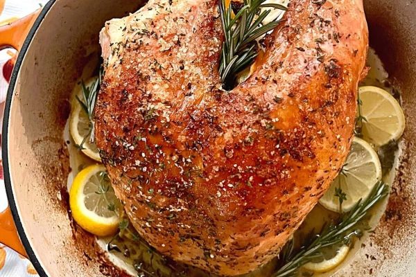 Oven roasted turkey breast in a Dutch oven with lemon and rosemary. 