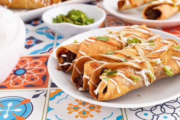 Beef taquitos on a plate.