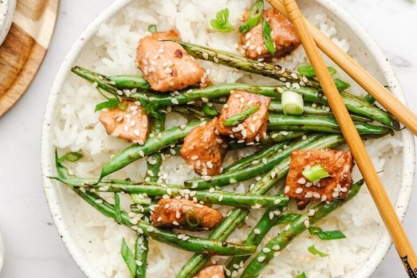 Salmon stir fried with veggies and served over rice.