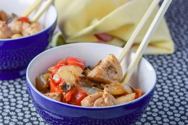 Easy Chicken Stir Fry served in a small bowl with chopsticks.
