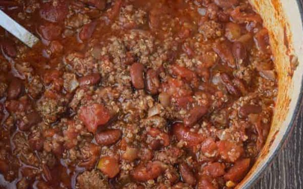 Chili with quinoa in an orange pot.