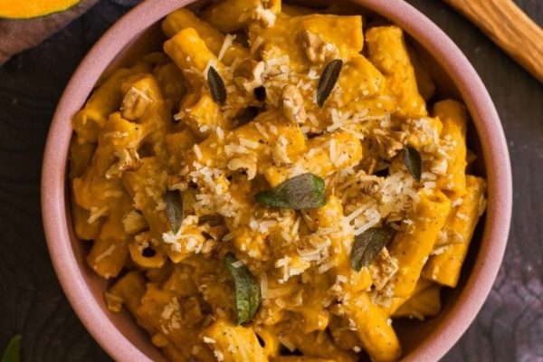 A bowl of pasta with pumpkin and sage.