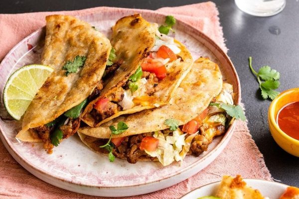 Turkey tacos on a plate with a lime wedge.