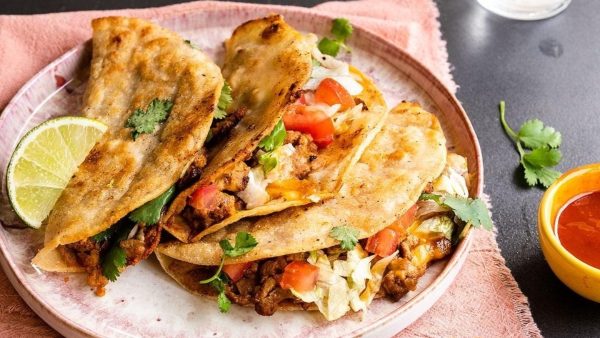 Turkey tacos on a plate with a lime wedge.