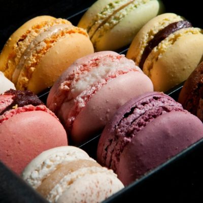 Box of various colors of french macarons.