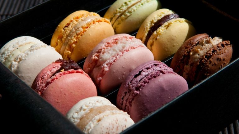 Box of various colors of french macarons.
