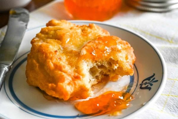 Scones with jam on a plate.