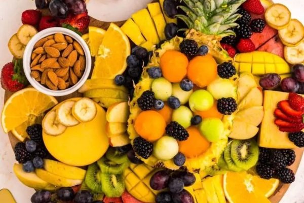 A charcuterie board filled with various fruits.
