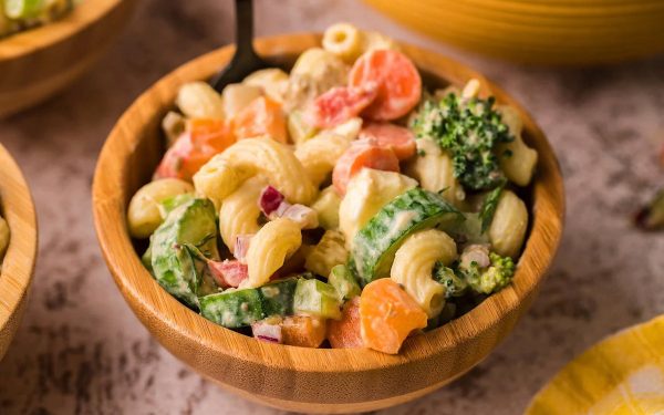 Garden veggie macaroni salad in a brown bowl.
