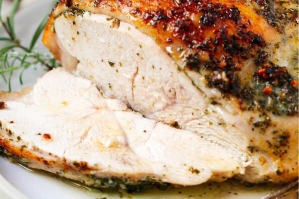 Garlic butter turkey breast sliced on a plate. 