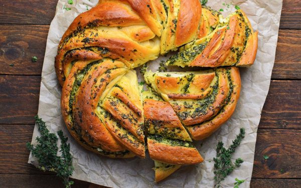 Garlic wreath with herbs on top.