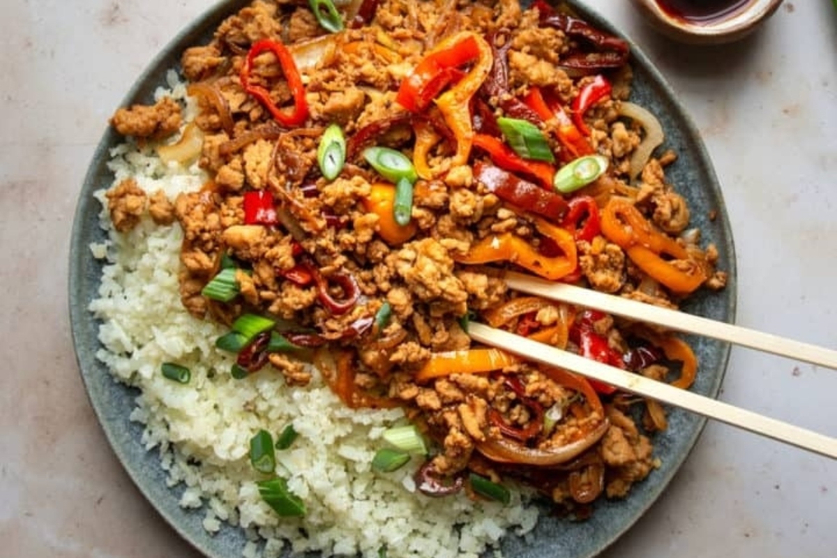 Ground chicken meat with sauce and thin slices of red pepper and onion. Served over rice.