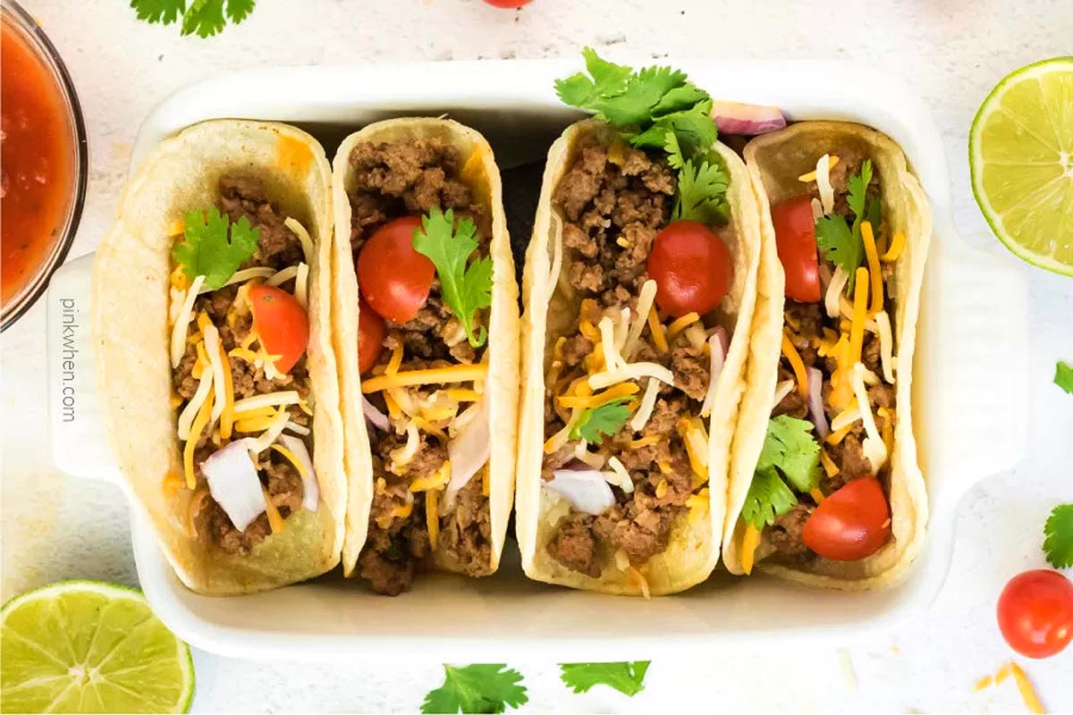 Tacos made with ground beef in a serving dish.