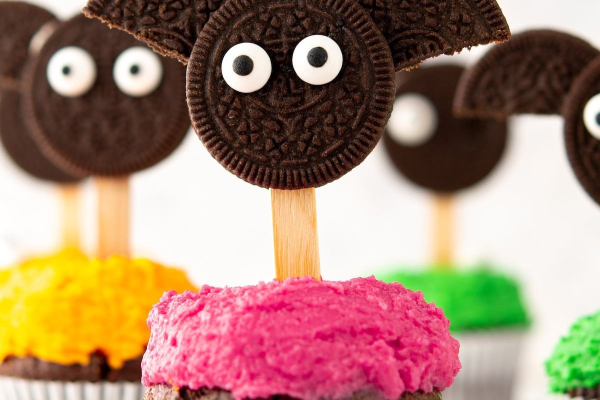 Halloween bat cupcakes with an oreo on top.