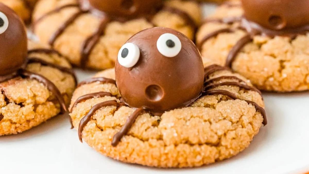 Peanut butter cookies decorated to look like spiders.