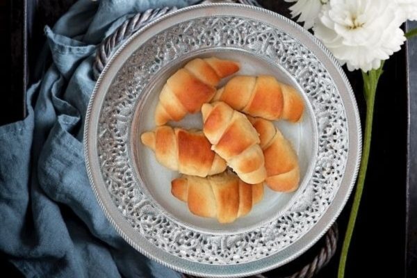 Homemade Crescent Rolls served on a round plate. 