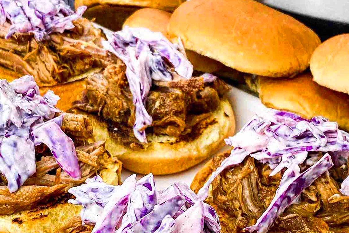 Pulled pork sliders with red cabbage on top.