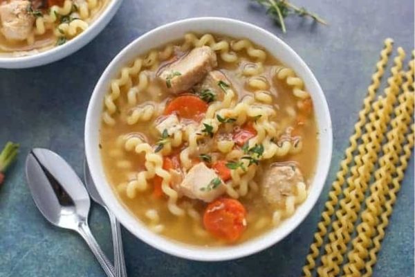 A bowl of Instant Pot Chicken Soup with pasta. 