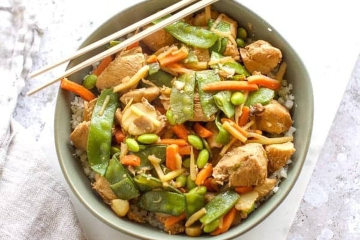 Chicken stir fry with  snap peas and carrots.