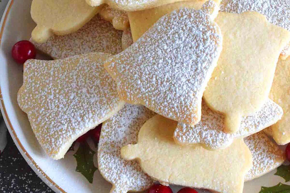 Powdered sugar sprinkled bell-shaped cookies.