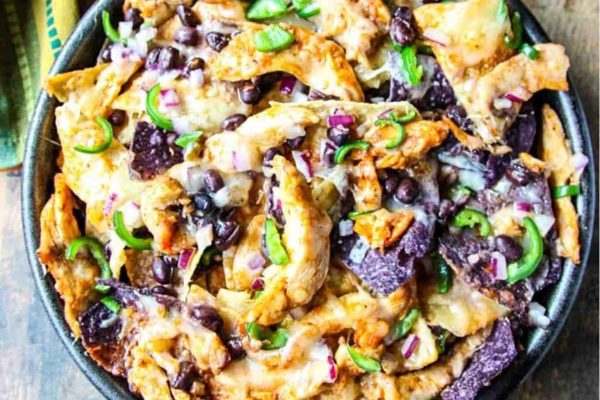 Nachos on a bowl with leftover turkey and various toppings. 