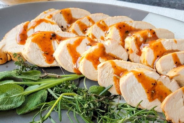 Maple Mustard Turkey Tenderloin served with herbs and a glaze. 