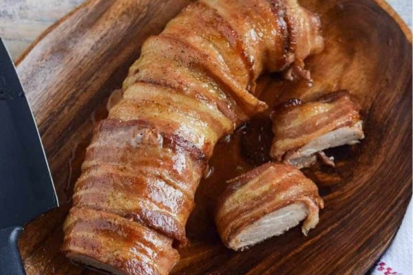 Maple Bacon Pork Tenderloin served on a wooden platter.