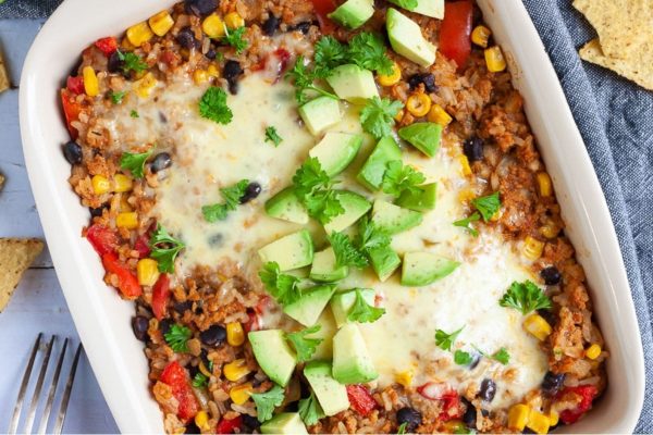 Mexican bean casserole with avocado on top.