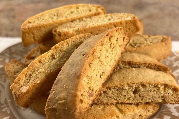 A plate with a stack of biscotti on it.