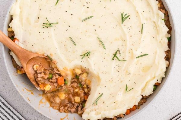 No-bake shepherd's pie on a round dish with a wooden spoon. 