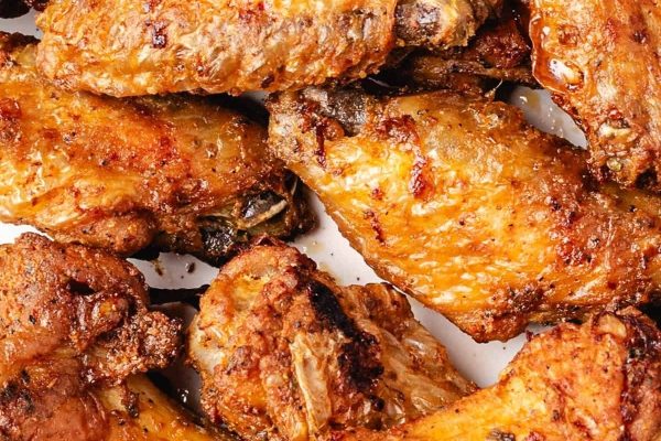 Oven fried chicken wings piled up. 