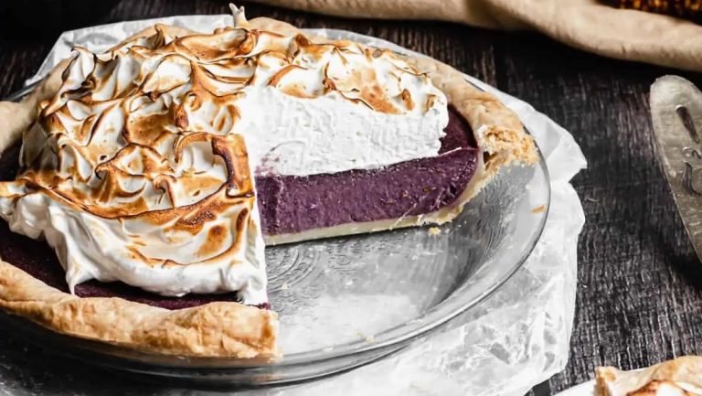 A delicious sweet potato pie with a slice taken out of it.