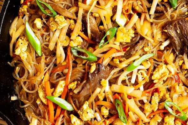 Pad Woon Sen (Thai Glass Noodles Stir Fry) on a cast iron skillet.