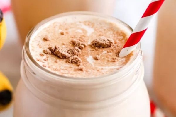 Peanut Butter Banana Smoothie with red and white straw.