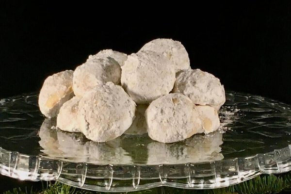 A stack of sugar cookies on a glass plate.