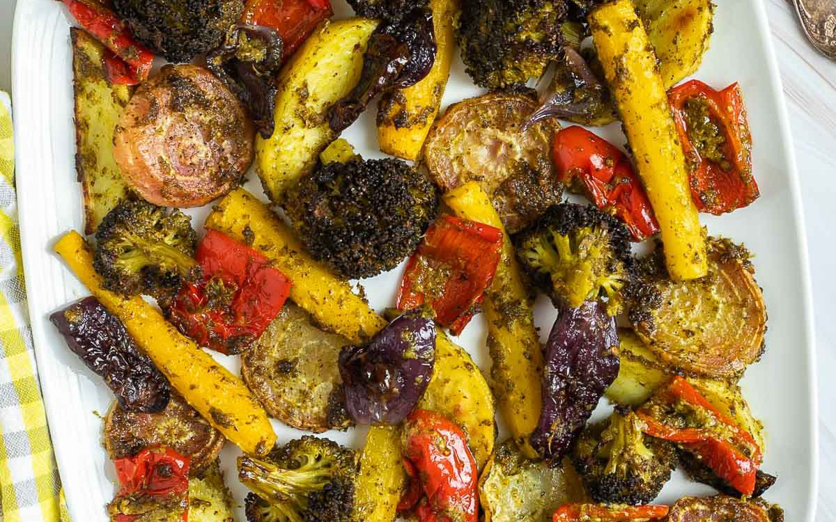 Sliced vegetables covered in pesto.