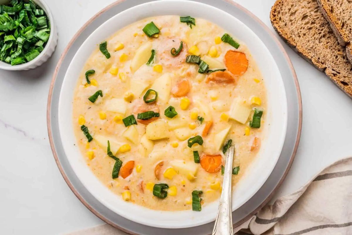 potato soup in a white bowl with spoon