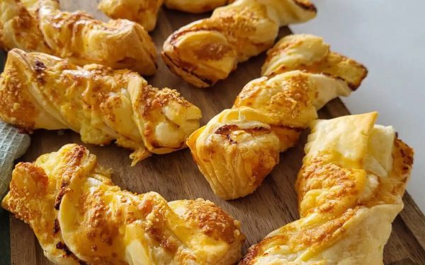 Puff pastry straws on a wooden board.