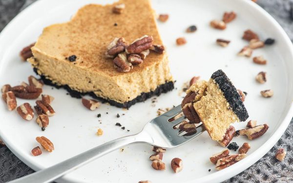 A slice of Pumpkin Cheesecake on a plate with fork