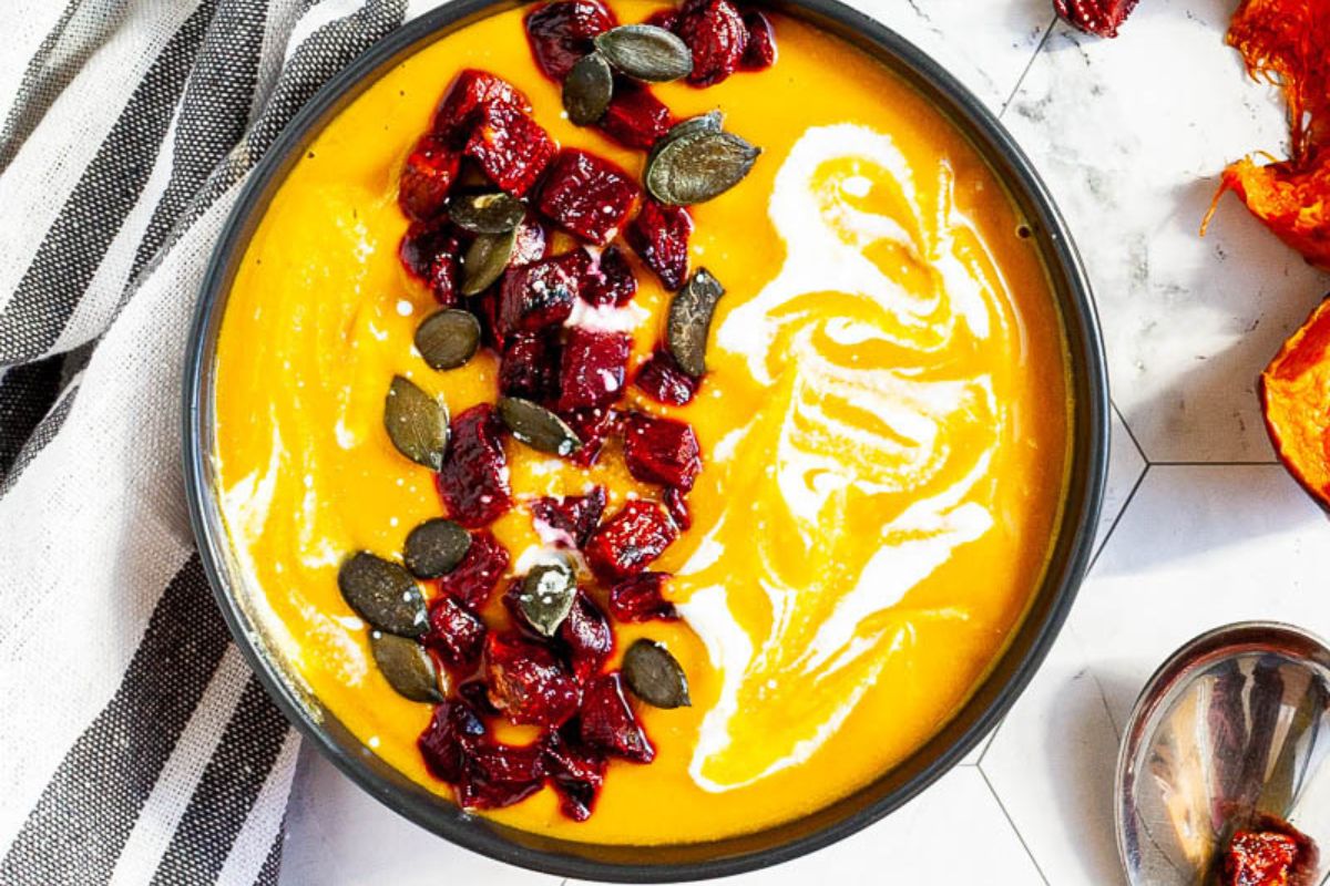 Roasted Pumpkin Sweet Potato Soup with pumpkin seeds on top.