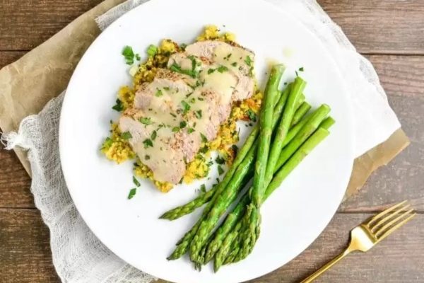 Roasted Lemon Pepper Pork Tenderloin with Cornbread Stuffing and asparagus.