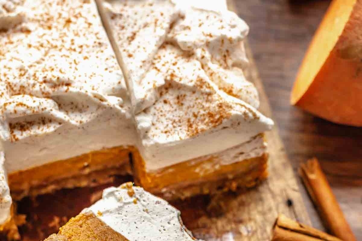 A slice of pumpkin pie on a cutting board, perfect for sweet potato recipes.