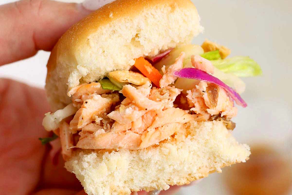 Sliders with salmon filet and a salad topping.